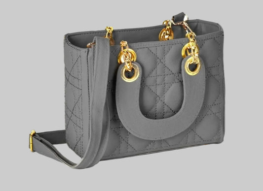 Gray handbag with gold hardware on a white background