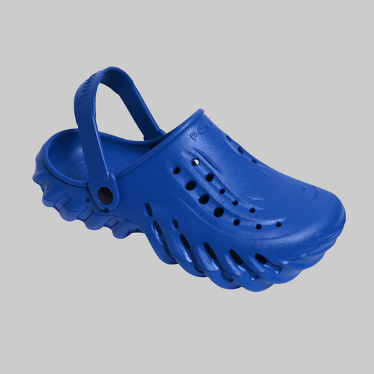 Blue clog shoe on a white background with a brand logo in the corner.