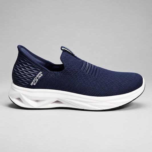 A single Skechers slip-on walking shoe in navy blue mesh with a thick beige cushioned sole, shown from a side profile against a light blue background.