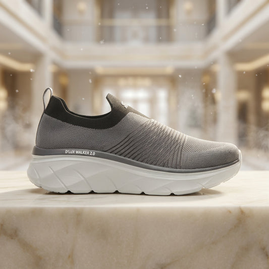 A single gray slip-on walking shoe with a thick white sole, shown in profile against a light gray background. The brand 'D'LUX WALKER 2.