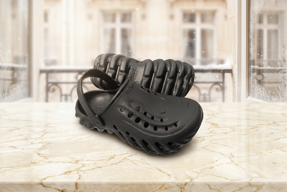 Black rubber sandal with textured sole on a white background