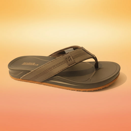 Gray sandal with brown sole on a white fabric background
