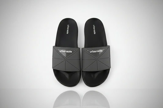 Black slides with gray straps on a white background, featuring the 'urbansole' brand.