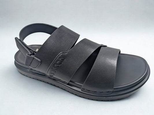 Black sandal with multiple straps on a light gray background