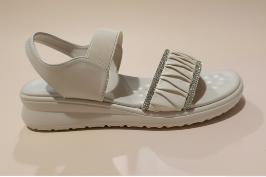 Beige sandal with a platform sole on a white surface