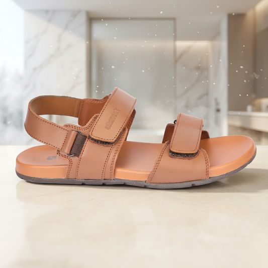 Tan sandal with velcro straps on a beige background