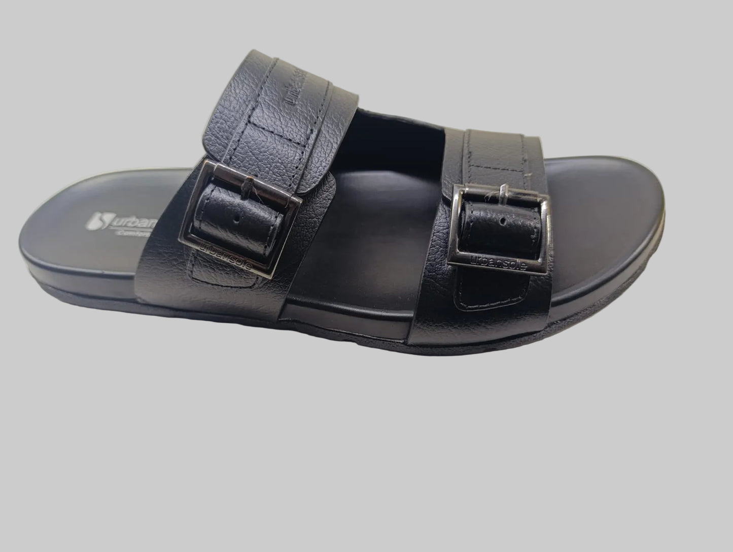 Black Slipper with two straps on a light background