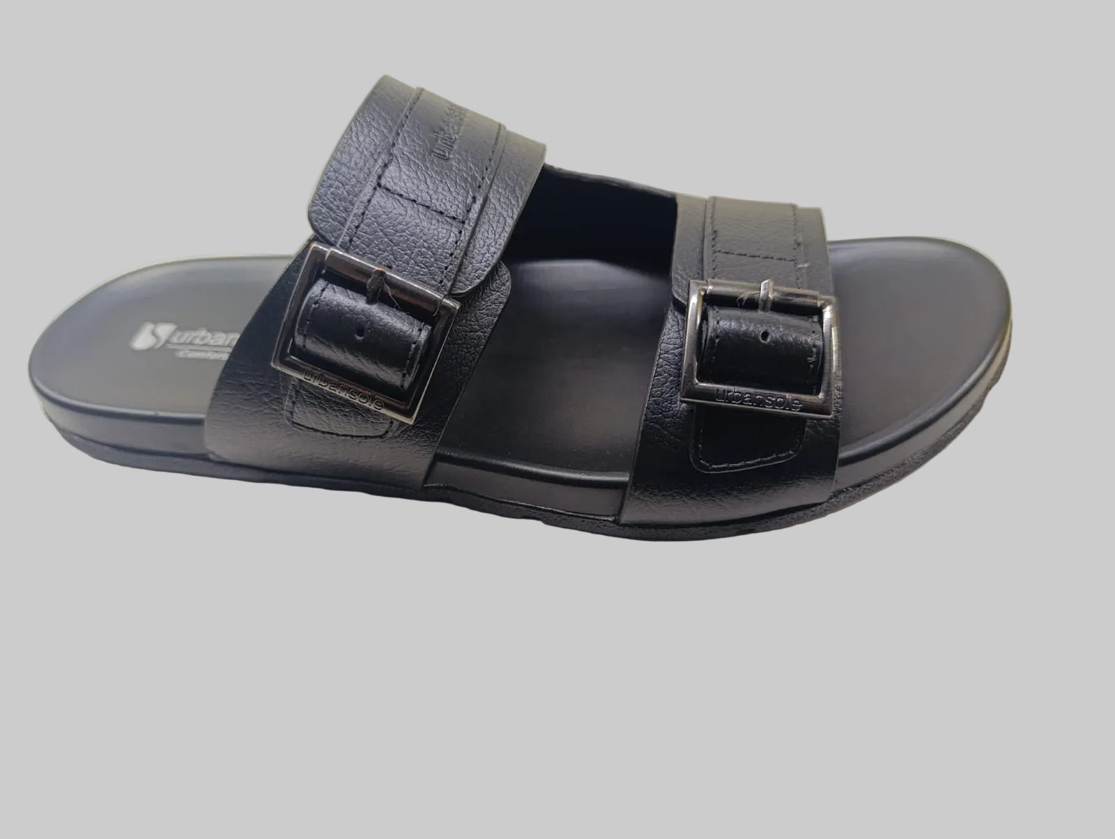 Black Slipper with two straps on a light background