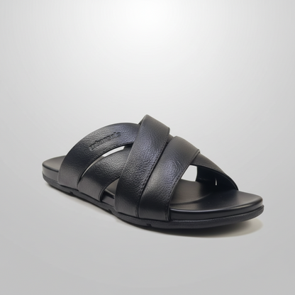 Black sandal with criss-cross straps on a light gray background