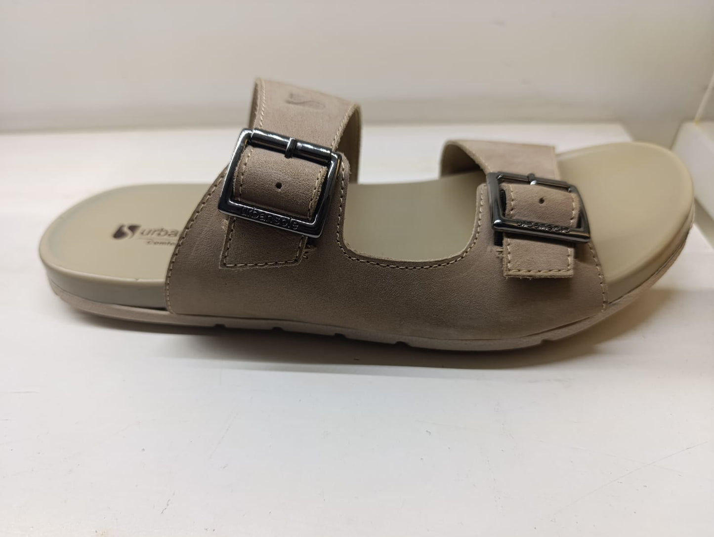 Pair of brown sandals with buckles on a white background