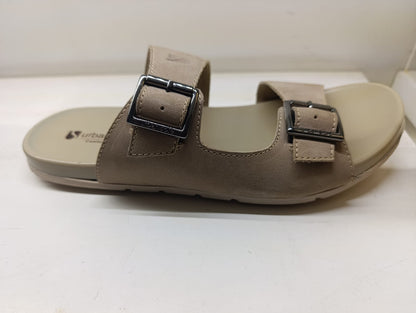Pair of brown sandals with buckles on a white background