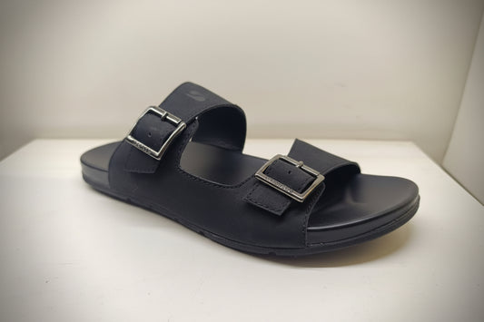 Black sandal with buckles on a white surface