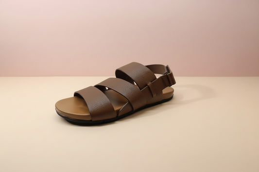 Brown sandal on a beige background