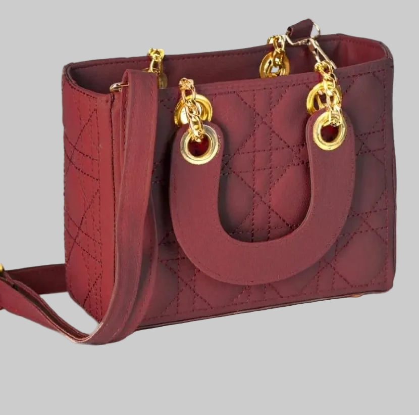 Red handbag with gold chain handles on a white background