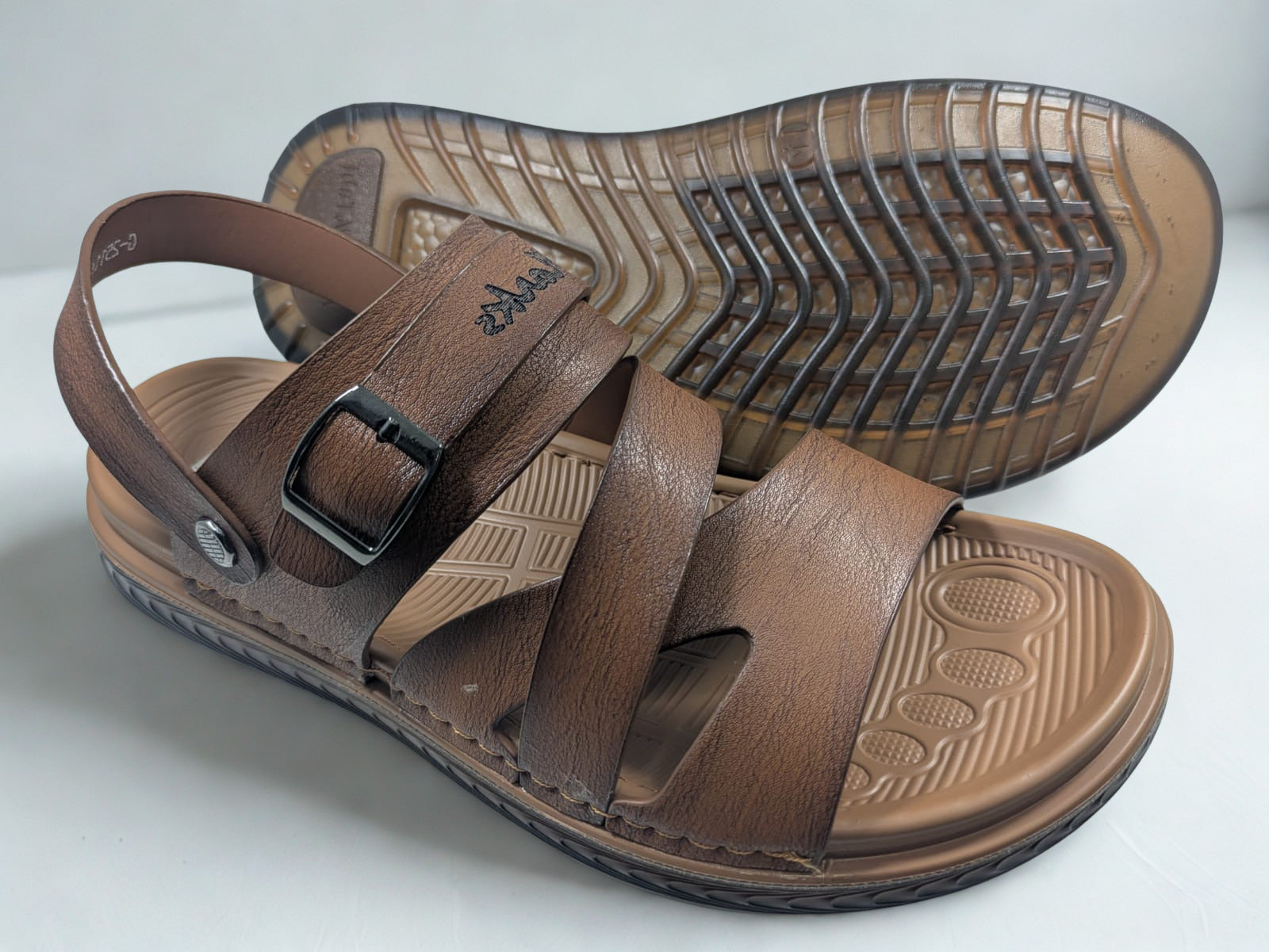 Brown sandals with a buckle on a white background