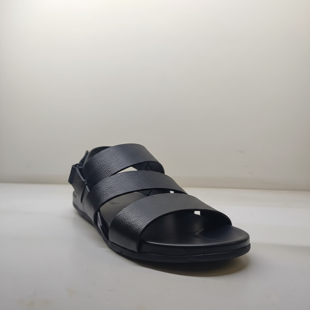 Black sandal with multiple straps on a light background