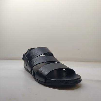 Black sandal with multiple straps on a light background