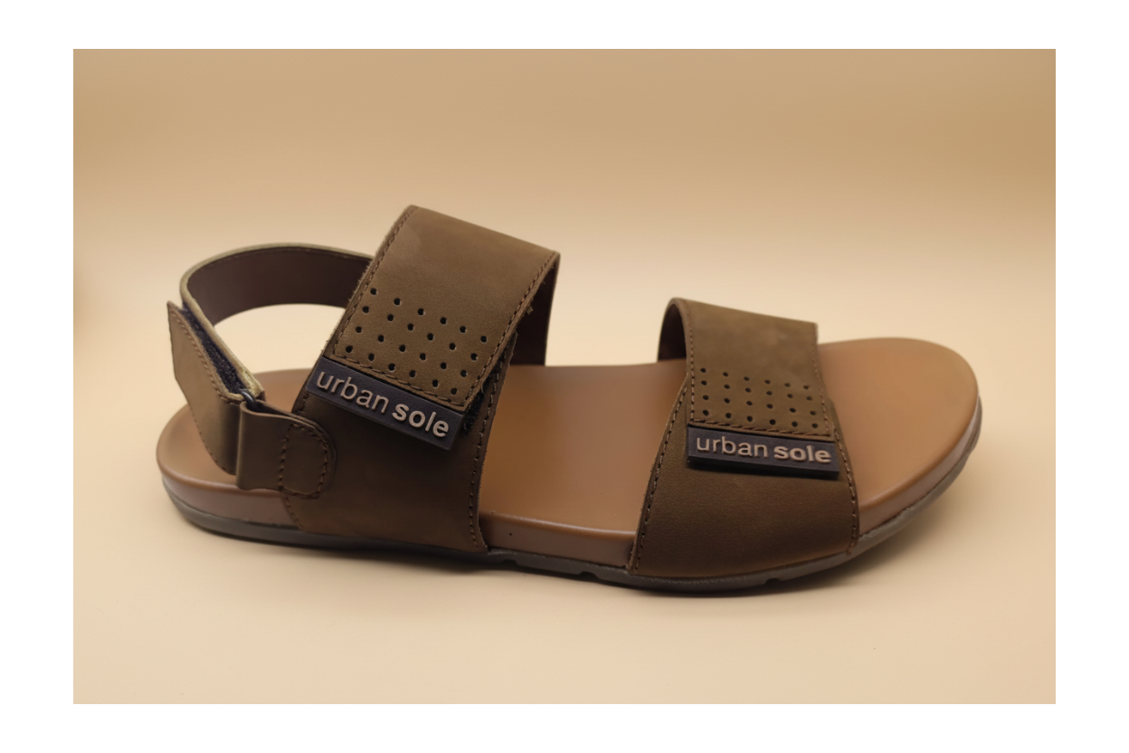 Brown sandal with 'urban sole' label on a beige background