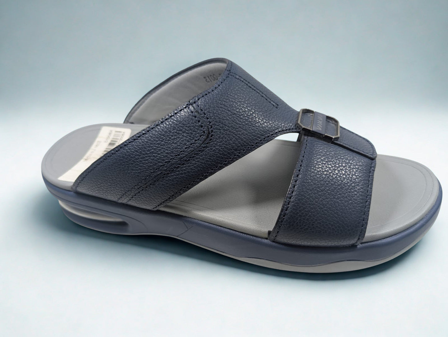 Blue sandal with a gray sole on a light blue background