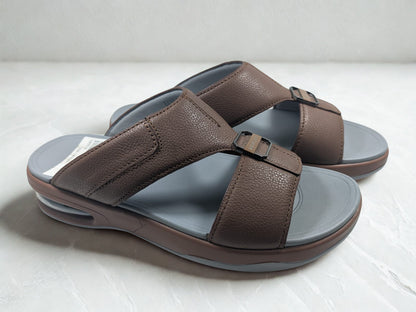Brown sandals with gray soles on a white background
