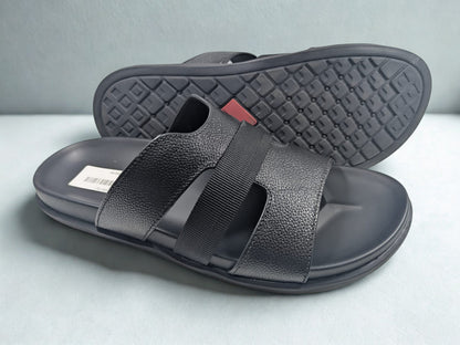 Black sandals with velcro straps on a light gray background