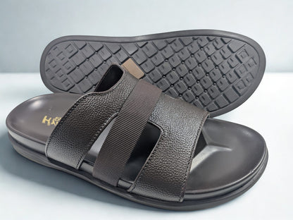 Brown sandal with a textured sole on a light gray background