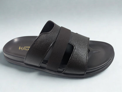 Black sandal with strap design on a light gray background