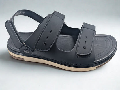 Black sandal with a strap on a light gray background