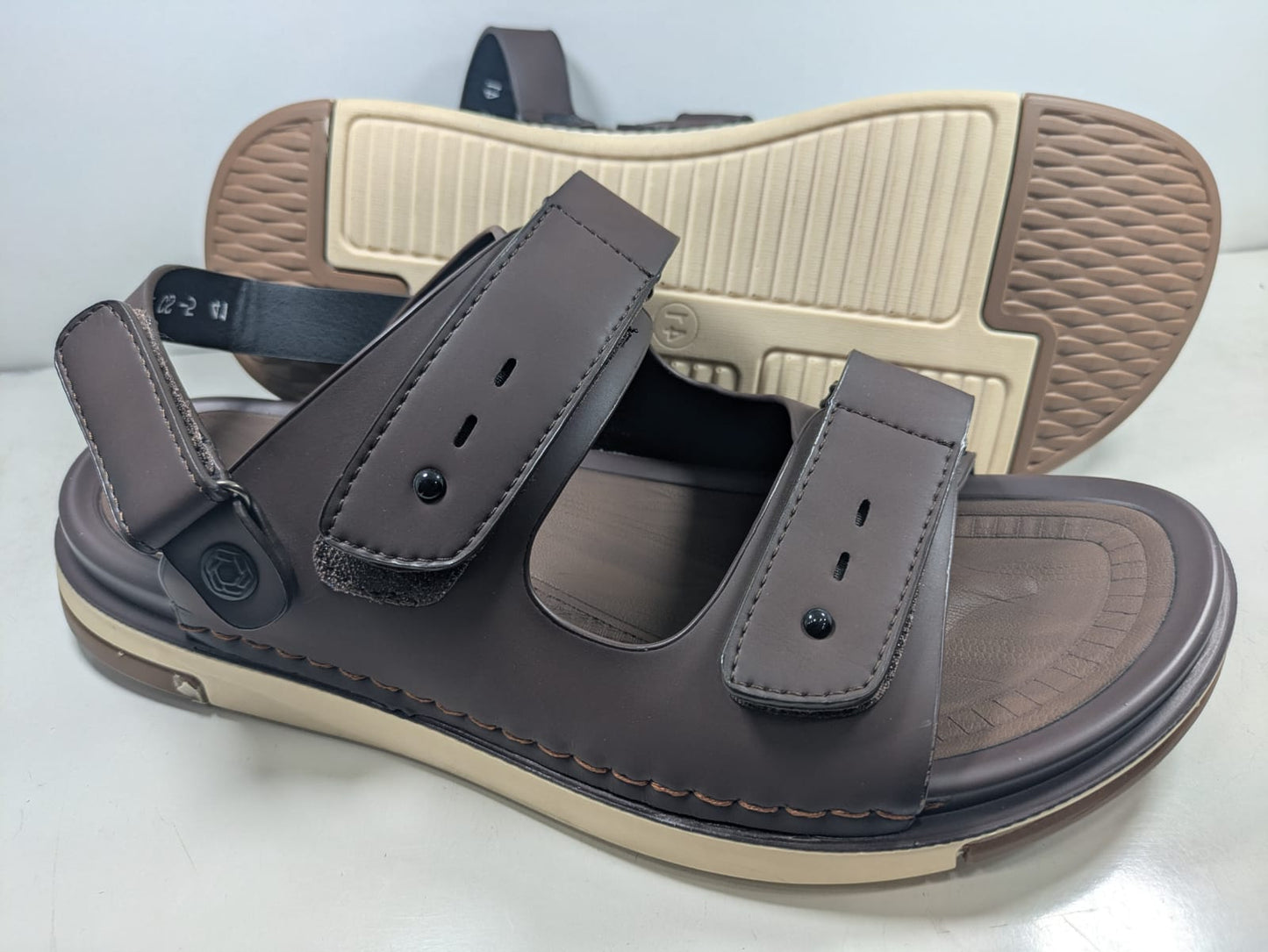 Brown sandal with beige sole on a white background