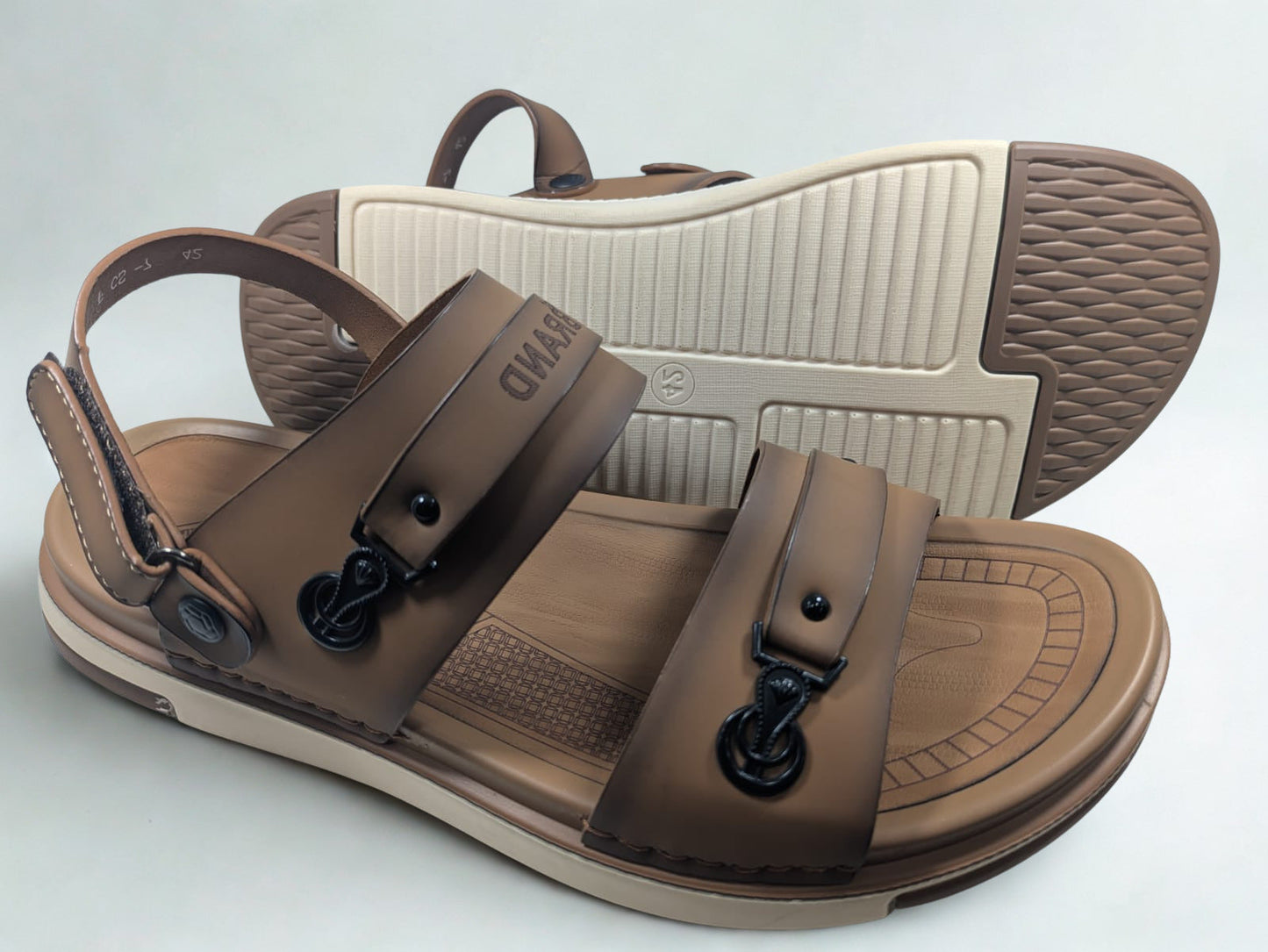 Brown sandals with black buckles on a light gray background