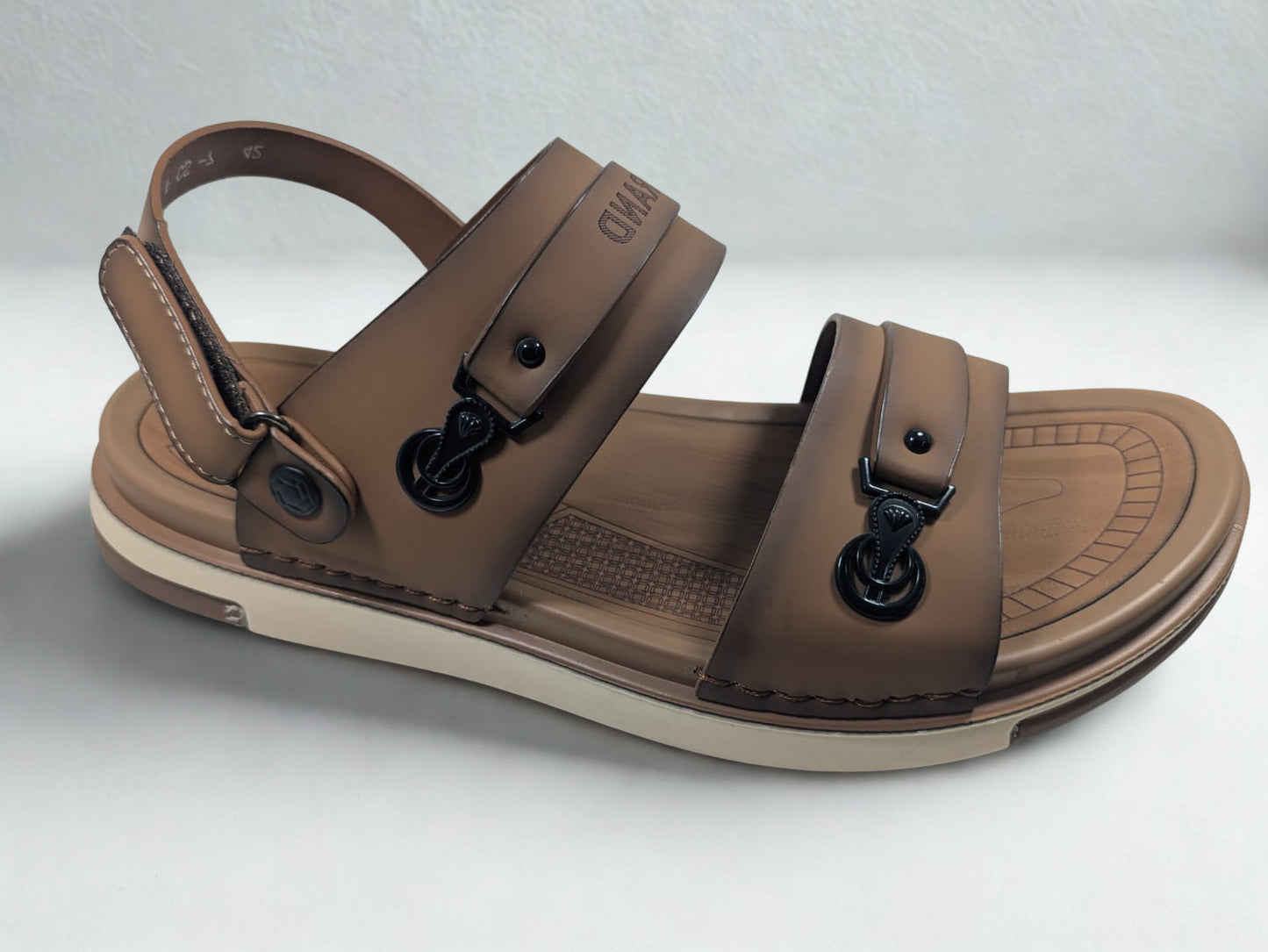 Brown sandal with black buckles on a light gray background