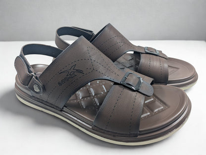 Pair of brown sandals with buckles on a white surface