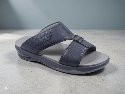 Blue sandal with gray sole on a light gray surface