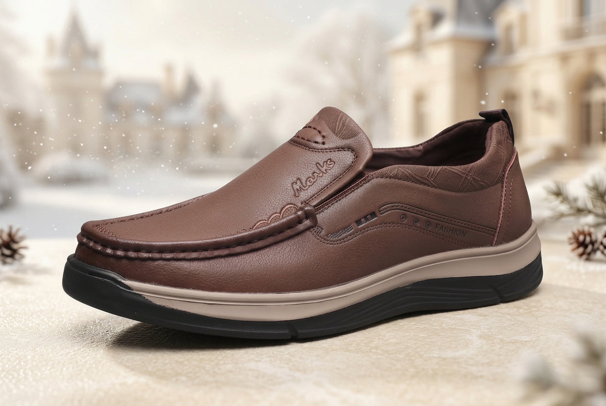 A brown slip-on leather shoe with a thick beige midsole and a black outsole, shown from a three-quarters angle on a white background.