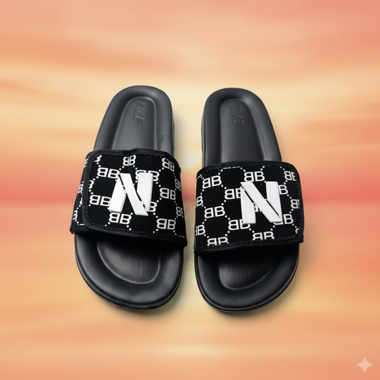 Black slides with patterned straps on a white background