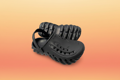Black rubber sandal with textured sole on a white background