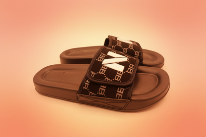 Black slide sandals with logo straps on a white background