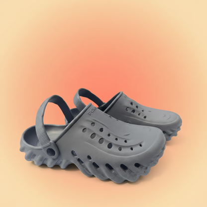 Pair of gray clogs on a white background