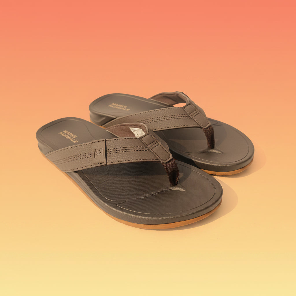 Pair of brown sandals with 'Marks & Fairwale' branding on a light fabric background