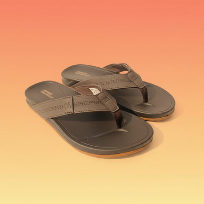 Pair of brown sandals with 'Marks & Fairwale' branding on a light fabric background