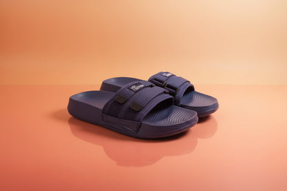 Pair of navy blue sandals with straps on a white background