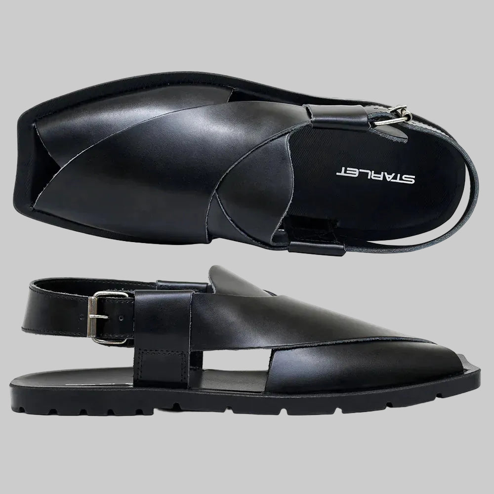 Black sandals with a buckle on a white background