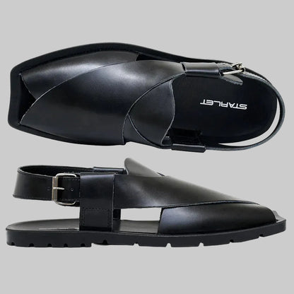 Black sandals with a buckle on a white background