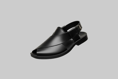 Black shoe floating in a shopping mall with blurred store fronts and people in the background