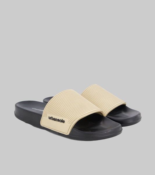 Beige and black slide sandals with 'urbansole' branding on a white background