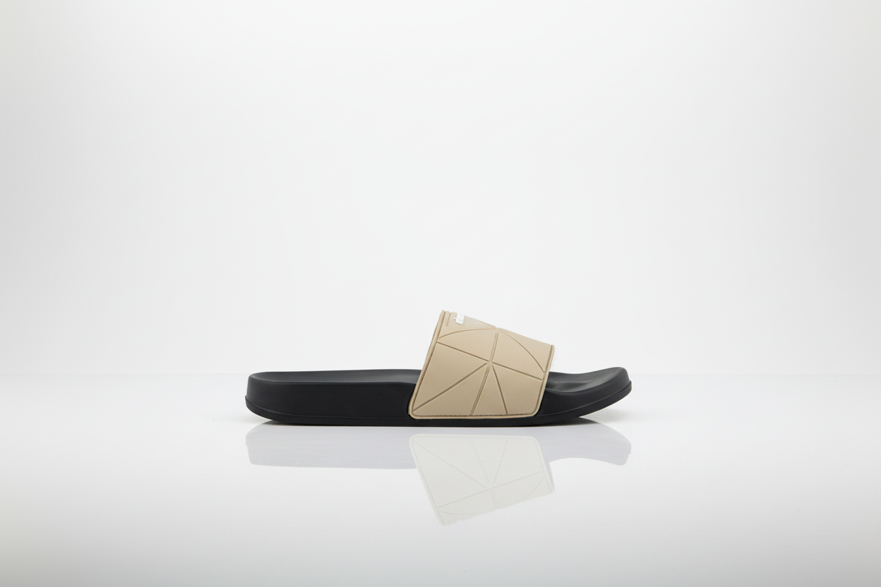 Black slide sandal with beige geometric design on a white background