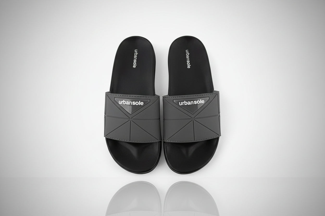 Black slides with gray straps on a white background, featuring the 'urbansole' brand.