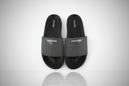 Black slides with gray straps on a white background, featuring the 'urbansole' brand.