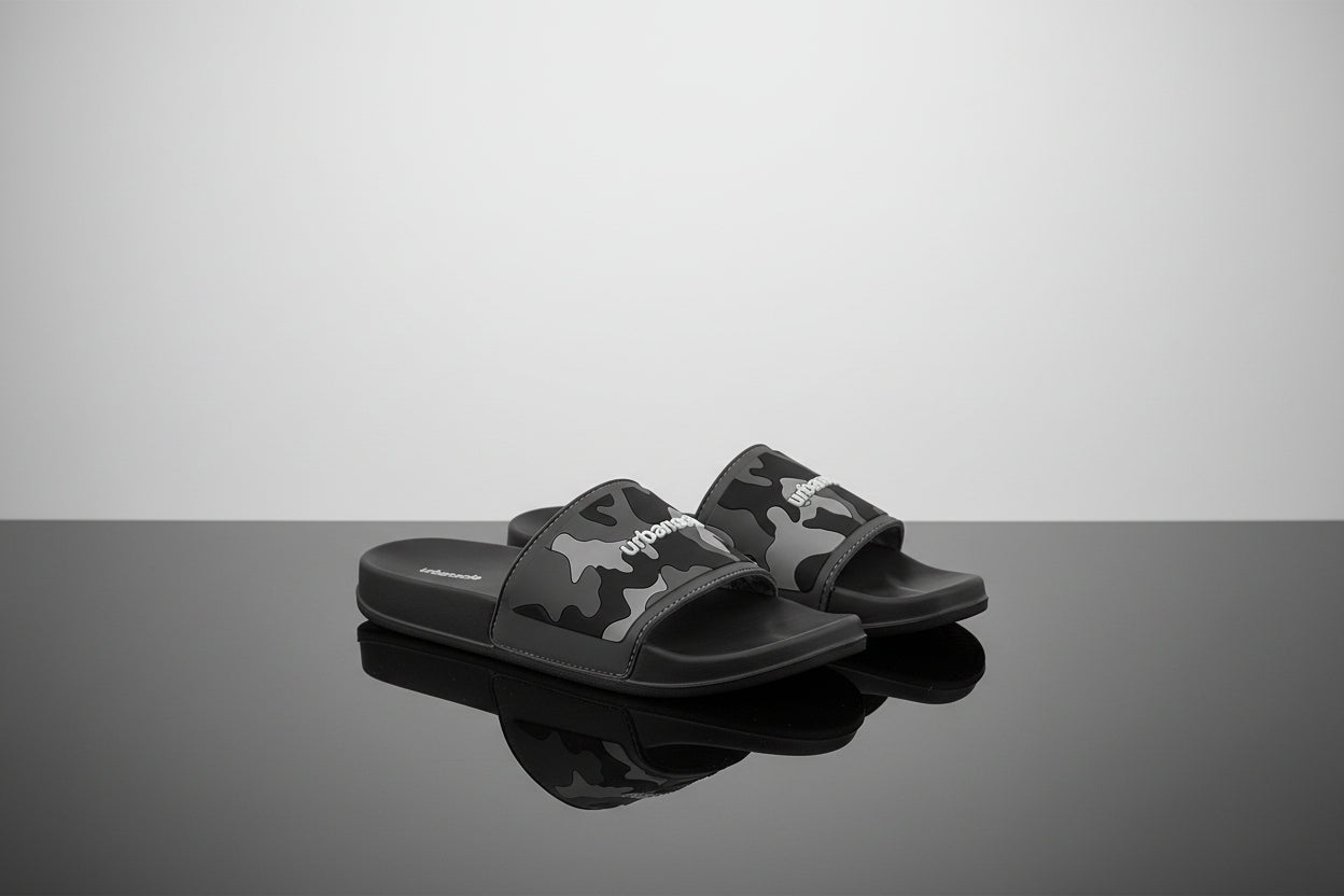 Black slides with camouflage pattern and visible brand logo on a white background
