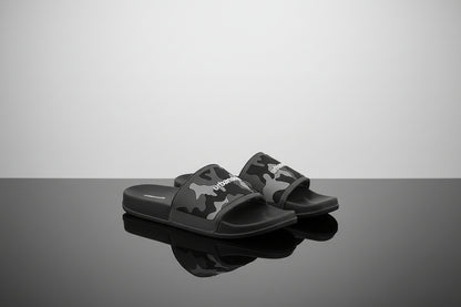 Black slides with camouflage pattern and visible brand logo on a white background